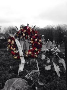 wreaths and flowers are placed in the grass