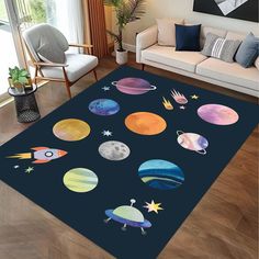 an area rug with planets and stars on it in a living room next to a couch