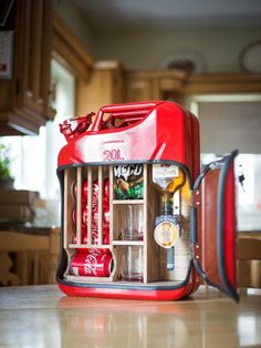 an open coca cola cooler sitting on top of a kitchen counter