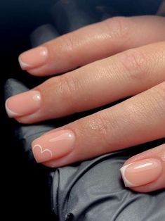 a woman's hand with french manies and a ring on her finger is shown