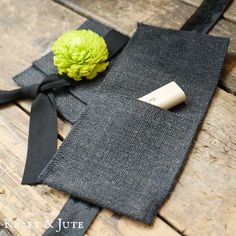 a piece of cloth with a flower on it sitting on top of a wooden table