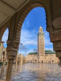 a large building with a clock tower in the middle of it's center courtyard