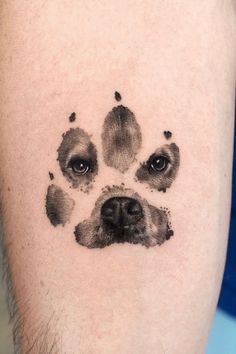 a dog's paw print is shown on the right arm and chest, with black ink all over it