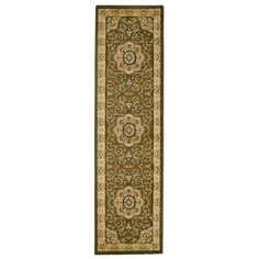 a green and beige rug with an intricate design on the bottom, in front of a white background