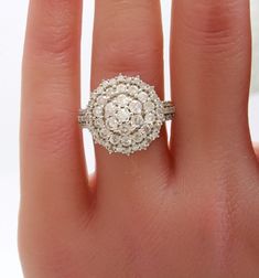 a woman's hand with a diamond ring on it