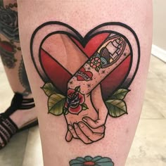 two hands holding each other in front of a heart with flowers and leaves on it