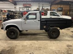 a white and black truck parked in a garage