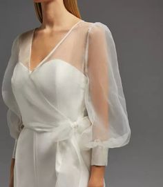 Wedding Sheer Cover Up/Organza Wrao Cover up for Bridal/Organza Blouse Bow tie Cover up/Minimal Wedding Dress Wrap Coat Style/Wrap Top XS----BUST:- 32, WAIST:-24, HIP:-34 S----BUST:- 34, WAIST:-26, HIP:-36 M----BUST:- 36, WAIST:-28, HIP:-38 L----BUST:- 38, WAIST:-30, HIP:-40 XL----BUST:- 40, WAIST:-32, HIP:-42 XXL----BUST:- 42, WAIST:-34, HIP:-44 Customized Your Size With us 𝐂𝐚𝐫𝐞 𝐈𝐧𝐬𝐭𝐫𝐮𝐜𝐭𝐢𝐨𝐧𝐬: * Dry Clean only * Do not soak in water 𝐍𝐨𝐭𝐞: 𝐏𝐫𝐨𝐝𝐮𝐜𝐭 𝐜𝐨𝐥𝐨𝐮𝐫 𝐦𝐚𝐲 𝐬𝐥𝐢𝐠𝐡𝐭𝐥𝐲 𝐯𝐚𝐫𝐲 𝐝𝐮𝐞 𝐭𝐨 𝐩𝐡𝐨𝐭𝐨𝐠𝐫𝐚𝐩𝐡𝐢𝐜 𝐥𝐢𝐠𝐡𝐭𝐢𝐧𝐠 𝐬𝐨𝐮𝐫𝐜𝐞𝐬 𝐨𝐫 𝐲𝐨𝐮𝐫 𝐦𝐨𝐧𝐢𝐭𝐨𝐫 Note-If you would like to custom size your dress, please leave a message in the notes of your order of your detailed size measurements for bustwaisthipshollow to floor with shoes Wedding Dress Wrap, Organza Ruffle Dress, Wrap Wedding Dress, Organza Bridal, Minimal Wedding Dress, Wedding Shrug, Sheer Cover Up, Organza Blouse, Bridal Tops