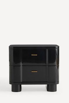 a black cabinet with two drawers and gold handles