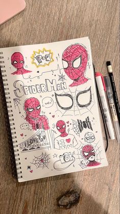 a notebook with spiderman drawings on it