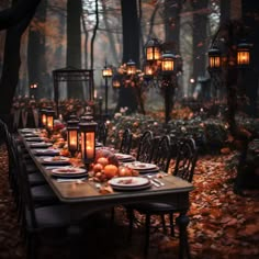 an outdoor dinner table set with candles and plates in the middle of leaves on the ground