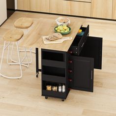 a kitchen island with two stools next to it and an open drawer on the side