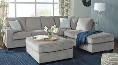 a living room filled with furniture and a blue rug