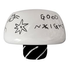 a white ceramic lamp with writing on it