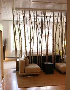 the living room is decorated with white birch trees