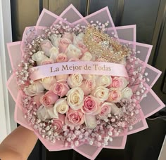 a bouquet of roses with a tiara on top is held in front of a door