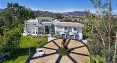 an aerial view of a large house in the hills