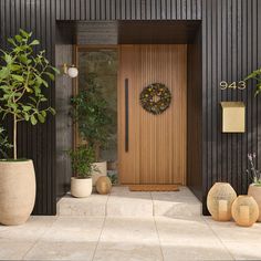 a front door with potted plants on either side