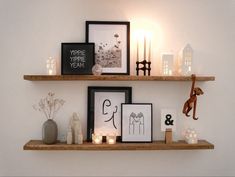 two wooden shelves with pictures and candles on them