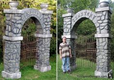 a man standing in front of a stone gate with an arch and name on it