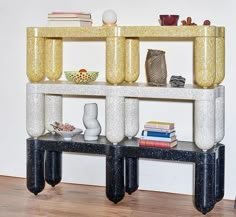 a shelf with books and vases on it