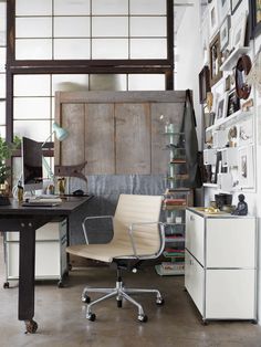 an office area with a desk, chair and bookshelf