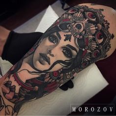 a woman's arm with tattoos on it and an eyeball in the middle