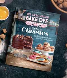 the great british bake off kitchen classics cookbook on a table with various cakes and desserts