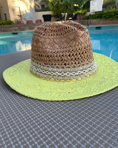 These are one of a kind Panama Hats! Featuring a hand painted brim, a unique and delicate hat ribbon, finished with cute little charms to brighten your day! The hat is constructed from 100% paper styled in a patterned weave accent. So super cute for the pool, the beach, bbq's, wine tasting, happy hour and more!! Makes a very special gift as well.Approx Measurements:Circumference: 22"Crown Height: 5.25"Brim: 3"100% Recycled Paper Fun Sun Hat With Short Brim For Spring, Fun Spring Sun Hat With Short Brim, Whimsical Brimmed Sun Hat For Summer, Adjustable Green Fedora For Spring, Playful Adjustable Hats For Spring, Handmade Cute Summer Hat, Fun Spring Straw Hat, Whimsical Spring Sun Hat, Playful Adjustable Brimmed Straw Hat