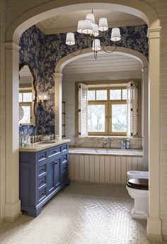 a large bathroom with blue and white decor