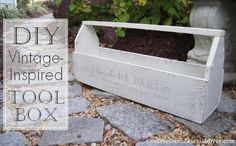 a white planter sitting on top of a stone floor