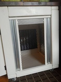 a white fireplace with a screen on the front and side panels that have been cut out