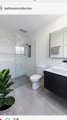 a modern bathroom with black and white decor