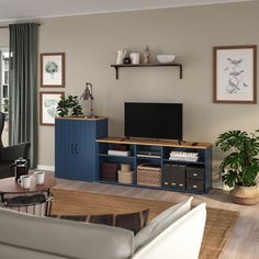 a living room filled with furniture and a flat screen tv on top of a wooden entertainment center