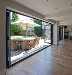 an open living room and dining area with sliding glass doors