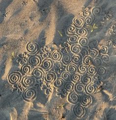 the sand has spiral designs on it