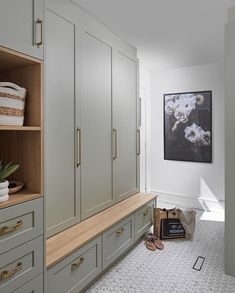 a large closet with lots of cabinets and drawers in it's center area, along with shoes on the floor