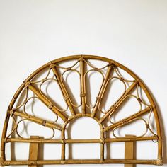 an arched bamboo shelf with hooks on it