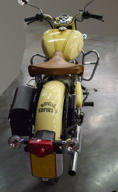 a yellow and black motorcycle parked in a garage