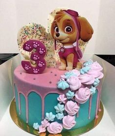 a birthday cake for a girl with a dog on top and flowers in the bottom