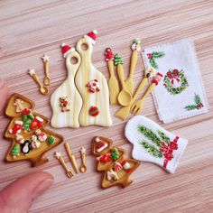 a person is holding out their hand to some cookies and other decorations on the table