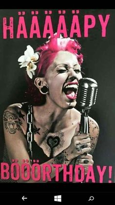 a woman with pink hair holding a microphone