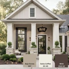 the exterior of a house with white trim and black shutters, brown doors, and gray