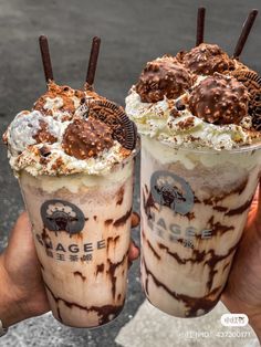 two ice cream sundaes with chocolate covered strawberries