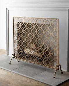 a fireplace screen sitting on top of a tile floor