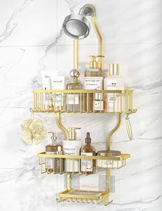 a gold shower shelf with soap, lotion and other items on it in front of a marble wall