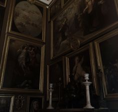 an ornate room with paintings on the wall