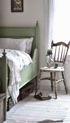 a bedroom with a green bed and wooden furniture