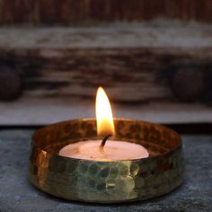 a lit candle sitting on top of a table