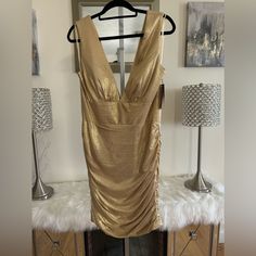 This Beautiful Abby Paris Formal Gown Dress Is Perfect For Any Special Occasion. The Stunning Gold Color And Mini Length Make It A Great Choice For Weddings, Pageants, Proms, And Other Formal Events. The Dress Is Designed For Women In Size 12 And Has A Regular Fit. The Dress Features A Wedding Theme And Is Made From High-Quality Materials To Ensure That It Is Comfortable And Durable. The Dress Length Is Short And The Style Is Perfect For A Formal Occasion. This Dress Is A Must-Have For Any Woman Gold Mini Dress For Wedding And Prom Season, Gold Ruched Mini Dress For Formal Occasions, Gold Ruched Dress For Formal Occasions, Gold Ruched Dress For Party Season, Gold Ruched Wedding Dress, Fur Dress, Denim Overall Dress, Paris Dresses, Formal Gown